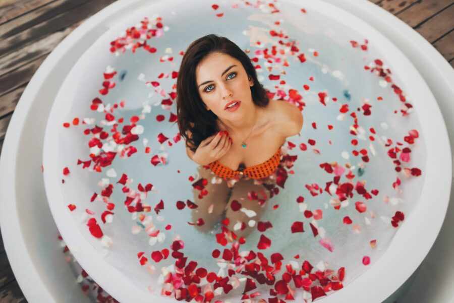 брюнетка в ванной с лепестками роз